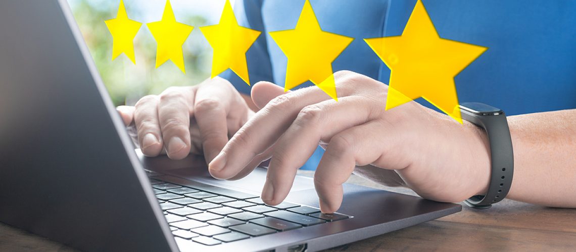close up customer man hand typing on keyboard laptop to giving 5 star to review service. 5star concept of testimonial and review, people use computer laptop for review rating online.